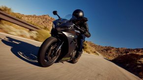 A 2024 Triumph Daytona 660 takes a sweeping corner.