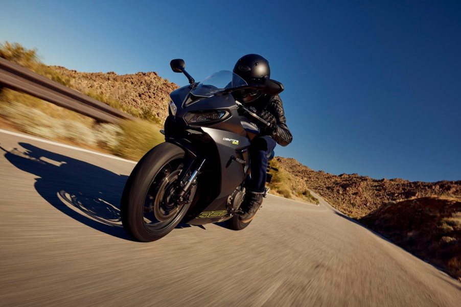 A 2024 Triumph Daytona 660 takes a sweeping corner.