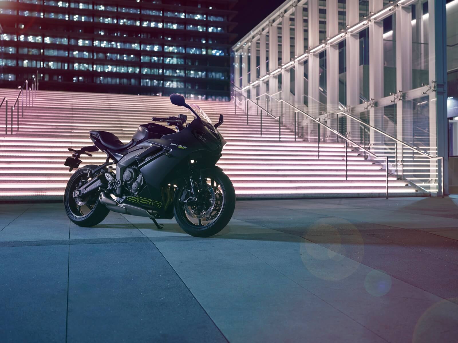 A black 2024 Triumph Daytona 660 parks in a city square.