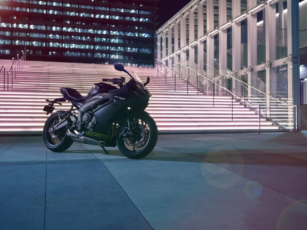 A black 2024 Triumph Daytona 660 parks in a city square.