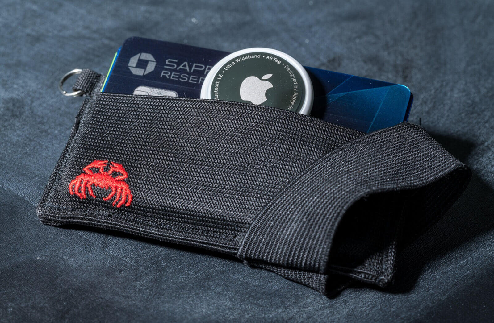 An Apple AirTag, which owners use to track their cars, fits into a wallet. 
