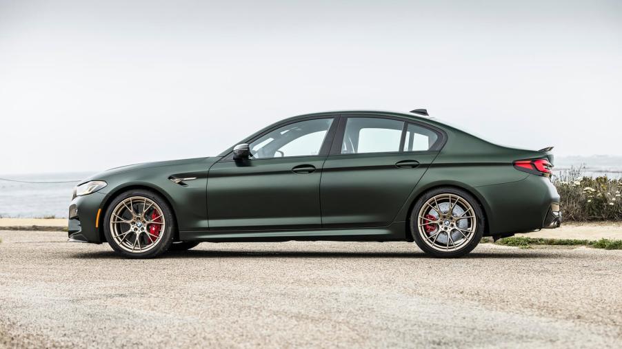 A green 2023 BMW M5 CS shows off its side profile.