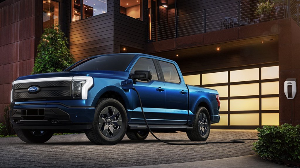 Blue F-150 Lightning Plugged In to the home charger.
