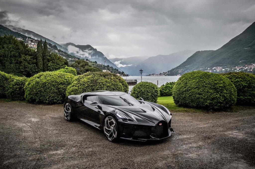 Black Bugatti Chiron special edition parked with a lake visible in the background.