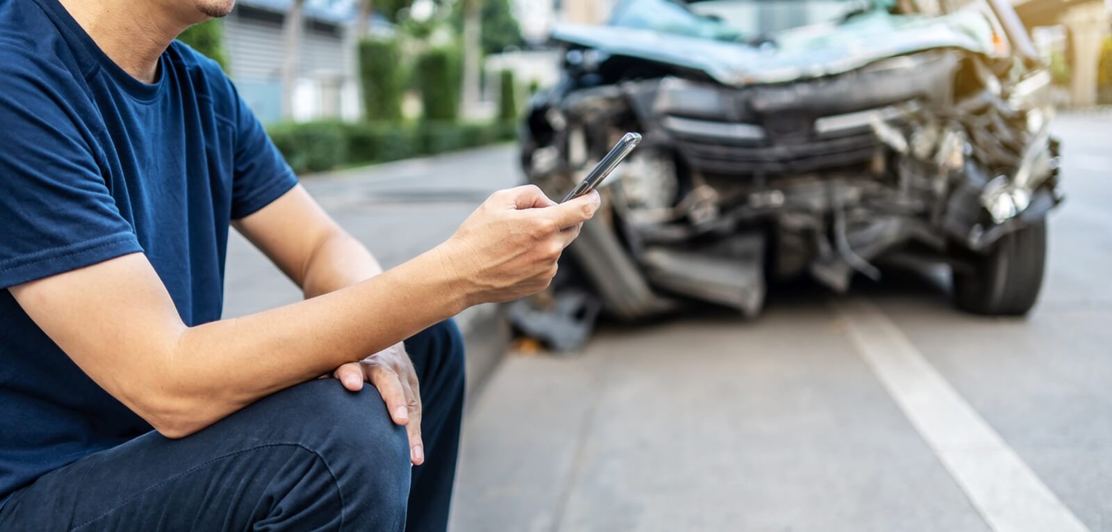 A driver calls his insurance provider after a wreck.