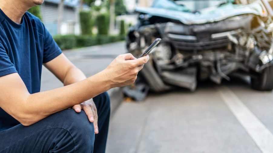A driver calls his insurance provider after a wreck.