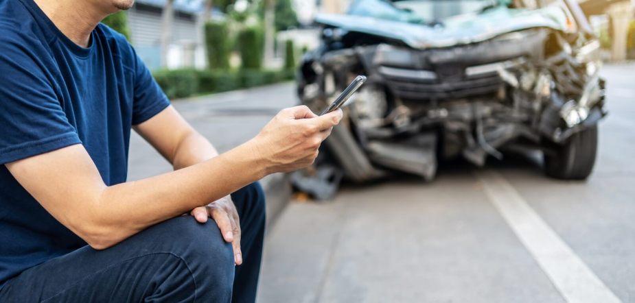 A driver calls his insurance provider after a wreck.