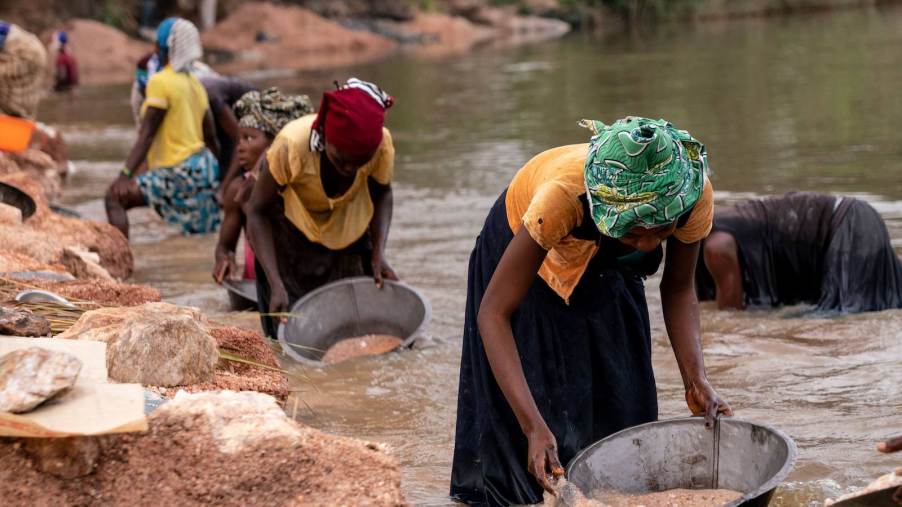 Women pan for precious chemicals in the Congo where lithium is common.