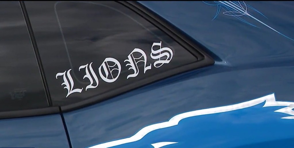 A Lions decal on a Dodge Challenger.