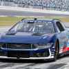 A 2024 Ford Mustang Dark Horse NASCAR Cup car on track