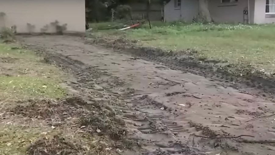 The dirt hole in a Florida woman's lawn, where her driveway once was.