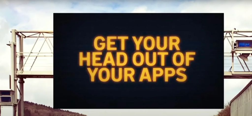 Render of a proposed NJ highway sign taht says "Get your Head out of your Apps"
