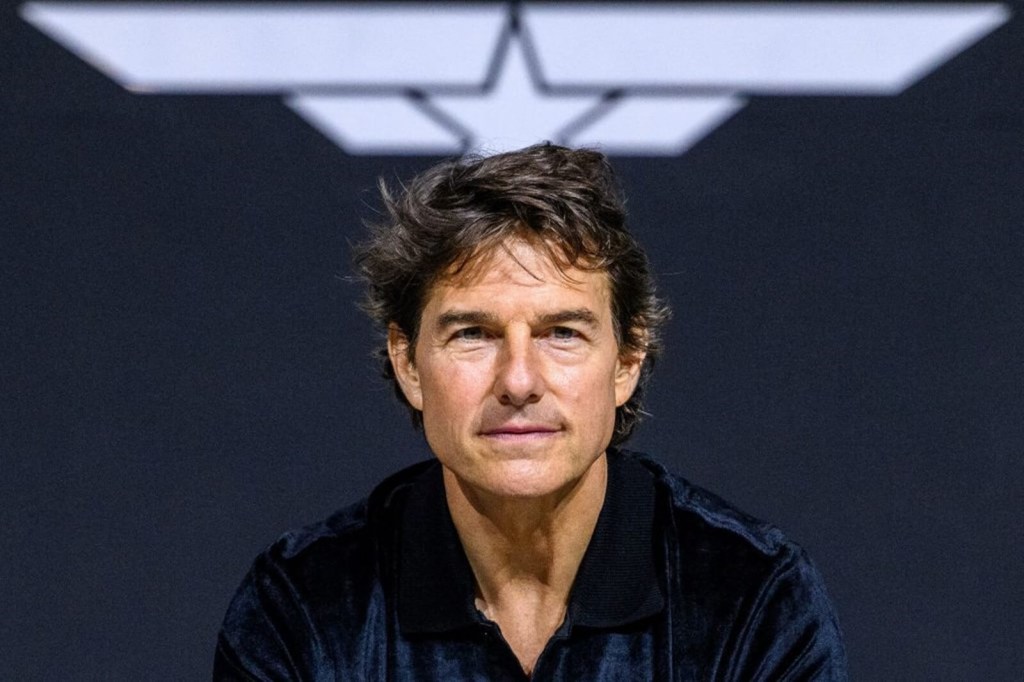 Tom Cruise smiles at a press event for "Top Gun: Maverick."