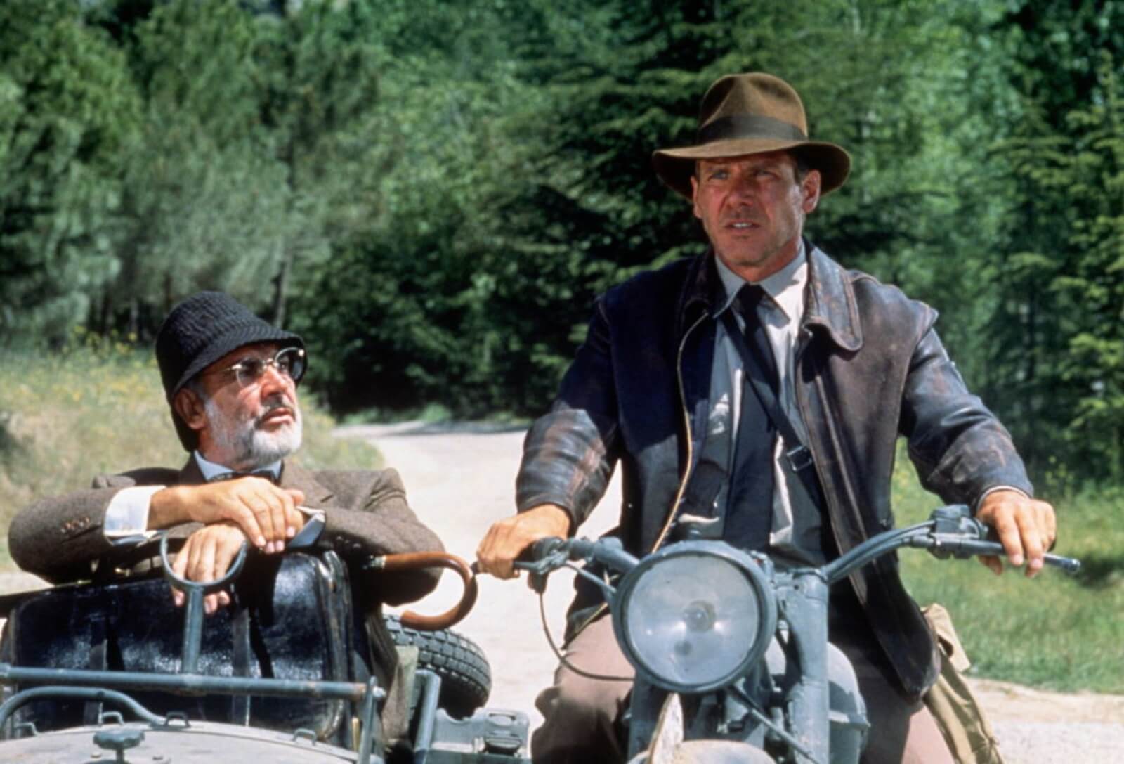 Harrison Ford and Sean Connery on a motorcycle for an Indiana Jones movie.