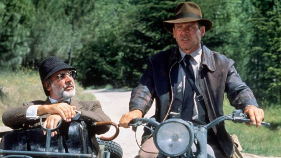 Harrison Ford and Sean Connery on a motorcycle for an Indiana Jones movie.