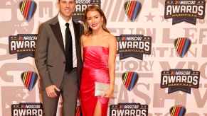 NASCAR Cup Series driver, Denny Hamlin and Jordan Fish pose for photos on the red carpet prior to the NASCAR Awards and Champion Celebration at the Music City Center on November 30, 2023 in Nashville, Tennessee.