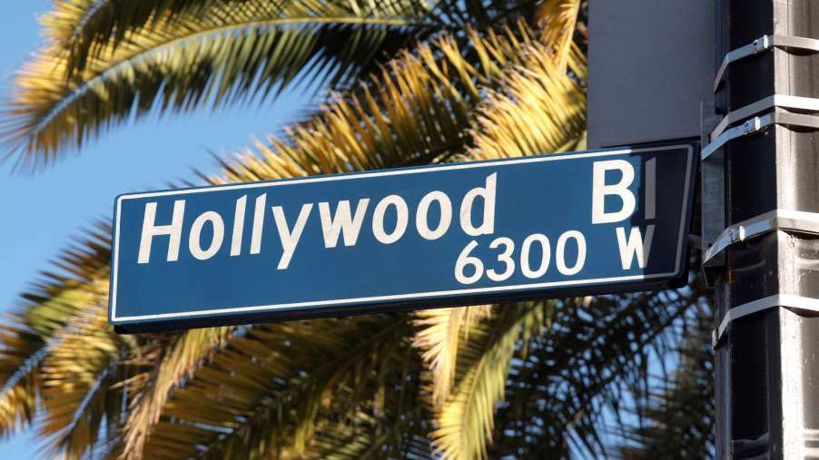 The sign for Hollywood Boulevard, with palm trees in the background.
