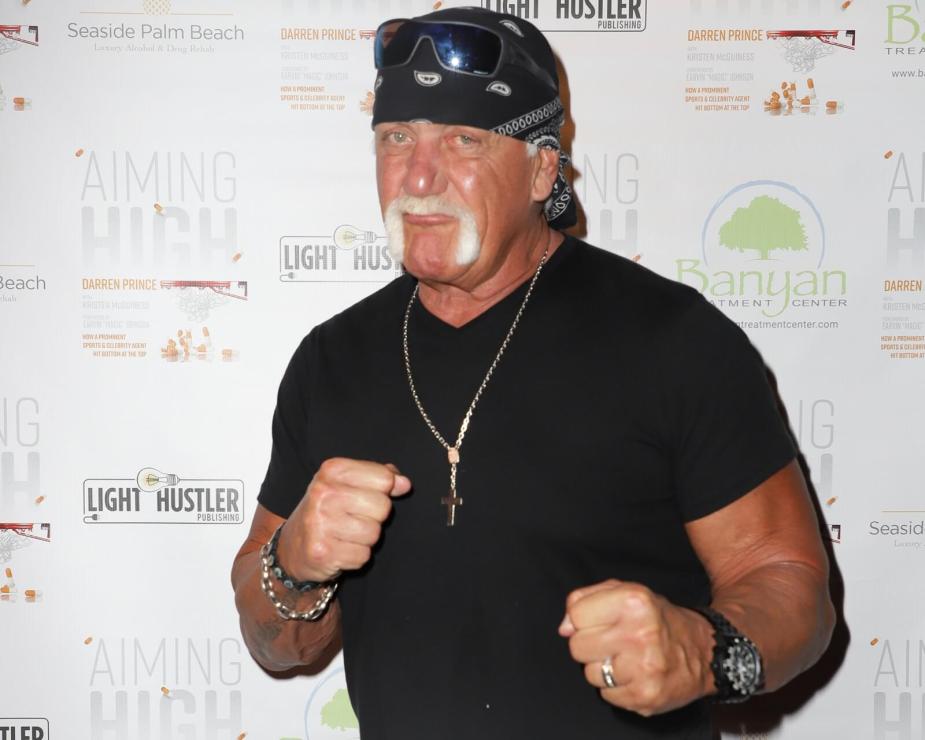 Hulk Hogan poses at an event after leaving his car.