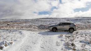 A Lexus hybrid electric SUV battles other cars, the snow, and cold weather.