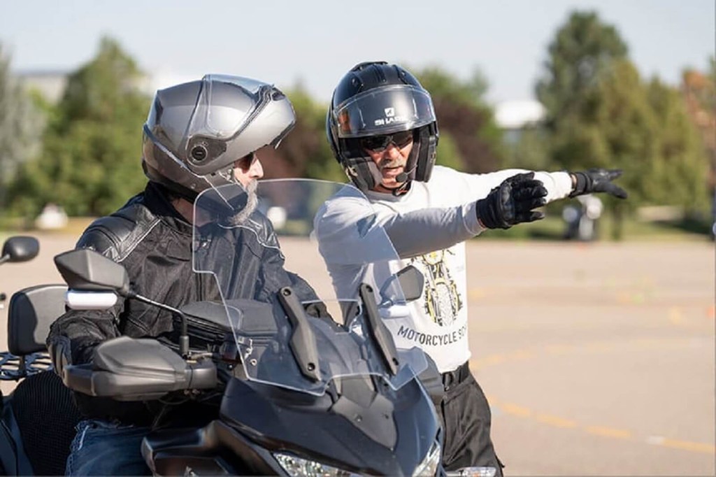 An MSF BRC instructor talks to a student before they test out for a motorcycle license.