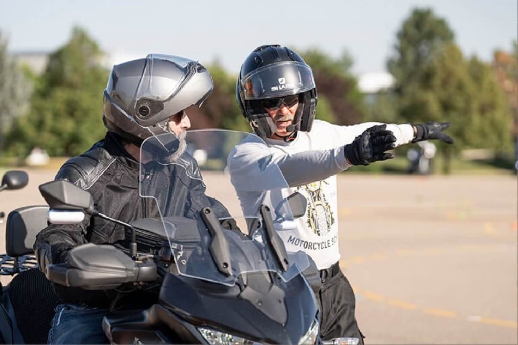 An MSF BRC instructor talks to a student before they test out for a motorcycle license. 