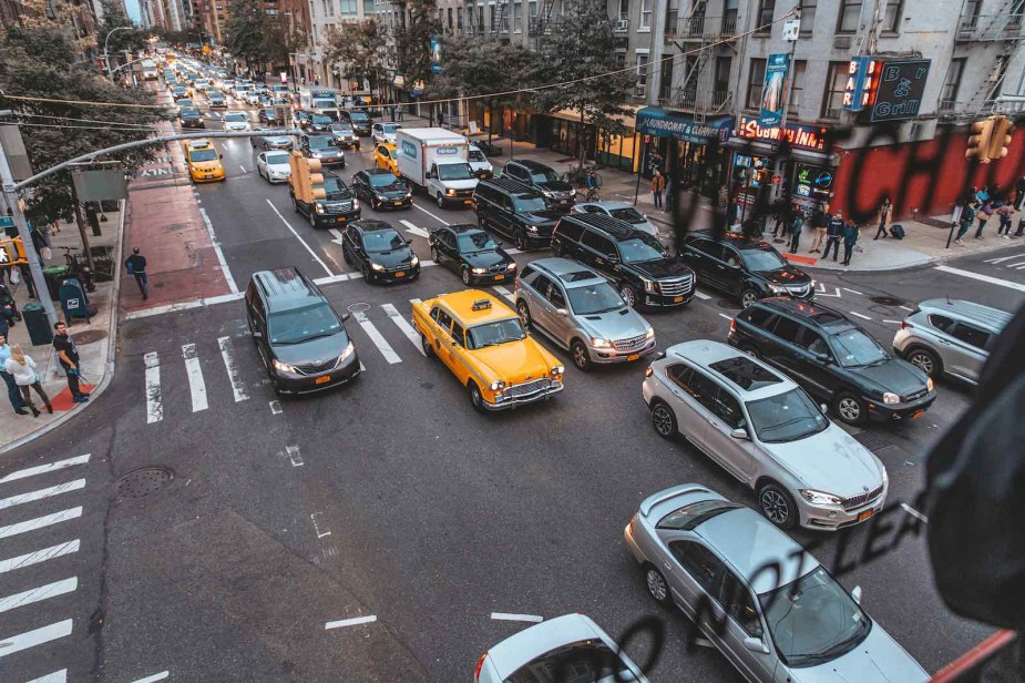 A row of cars and taxis stopped in a New York City rush hour traffic jam.
