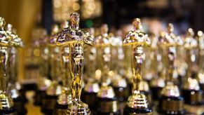 A row of golden academy award "Oscar" trophies