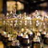 A row of golden academy award "Oscar" trophies