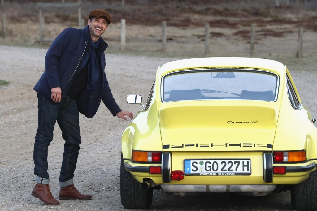 Patrick Dempsey poses with a Porsche 911 RS.
