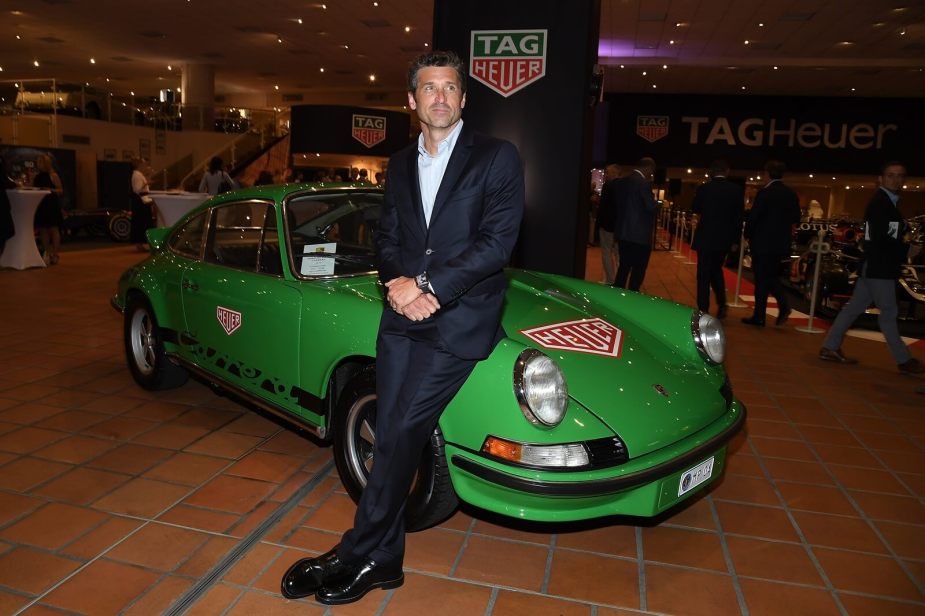 Patrick Dempsey with a green Porsche 911 at an event.