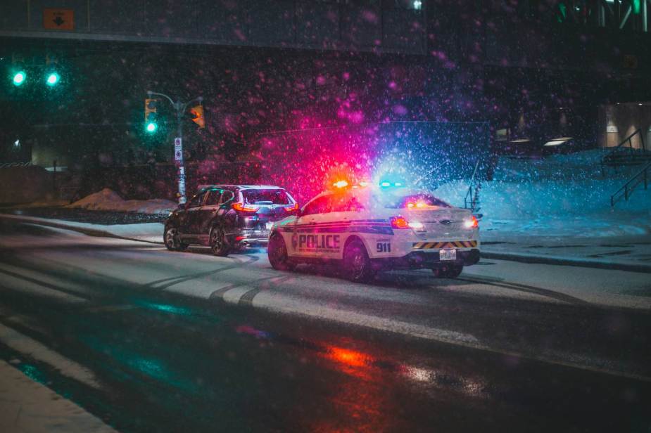 Police cruiser speeding ticket traffic stop in the snow.