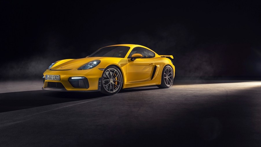 A yellow Porsche 718 Cayman GT4 shows off its front-end styling.