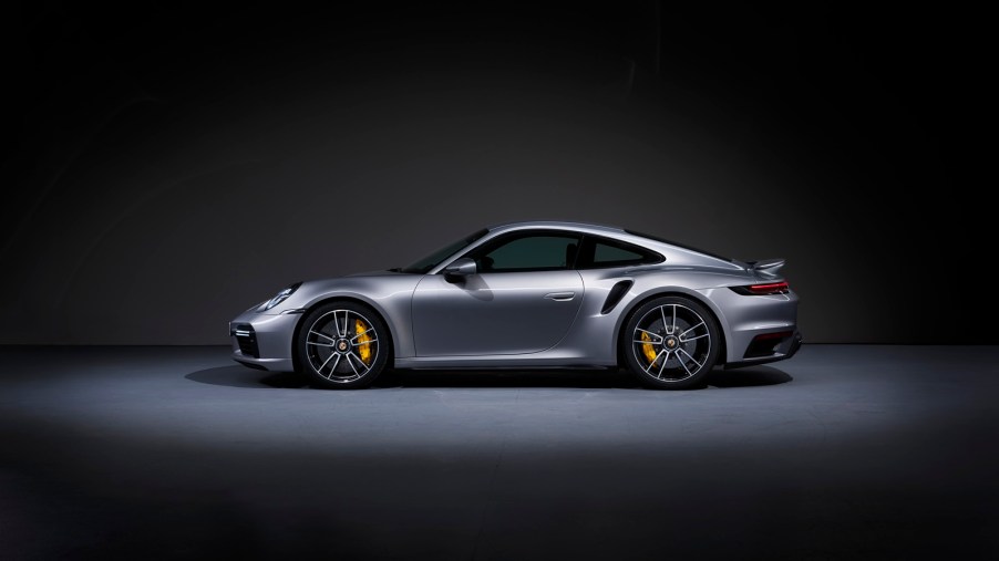 A silver Porsche 911 Turbo S, one of the models with the best depreciation rate, shows off its side profile.