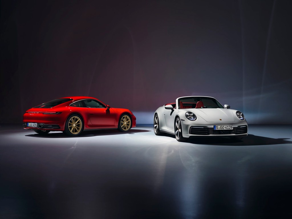 A set of 992 Porsches under an overhead light. 