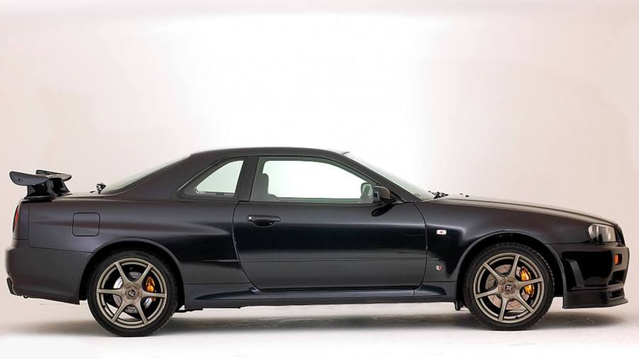 A 1999 Nissan Skyline GT-R shows off its profile.