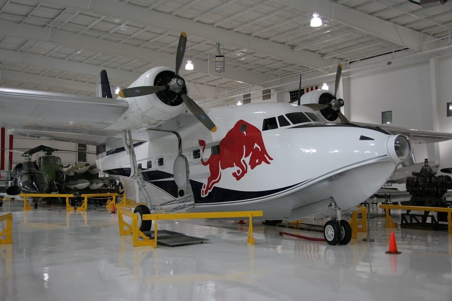 A white Grumman Albatross seaplane with the Redbull Logo on the side.