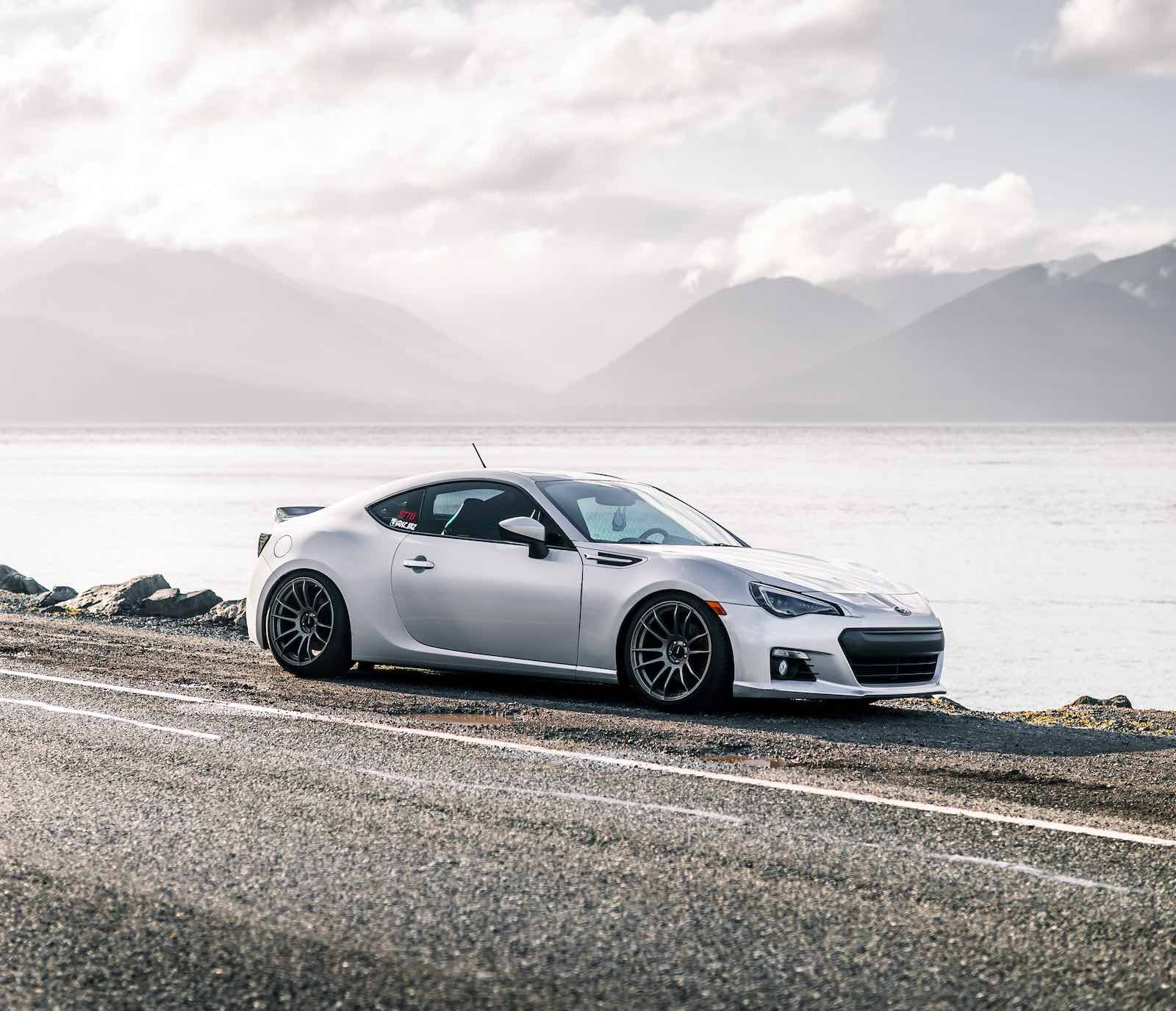 Silver Subaru BRZ parked by a river