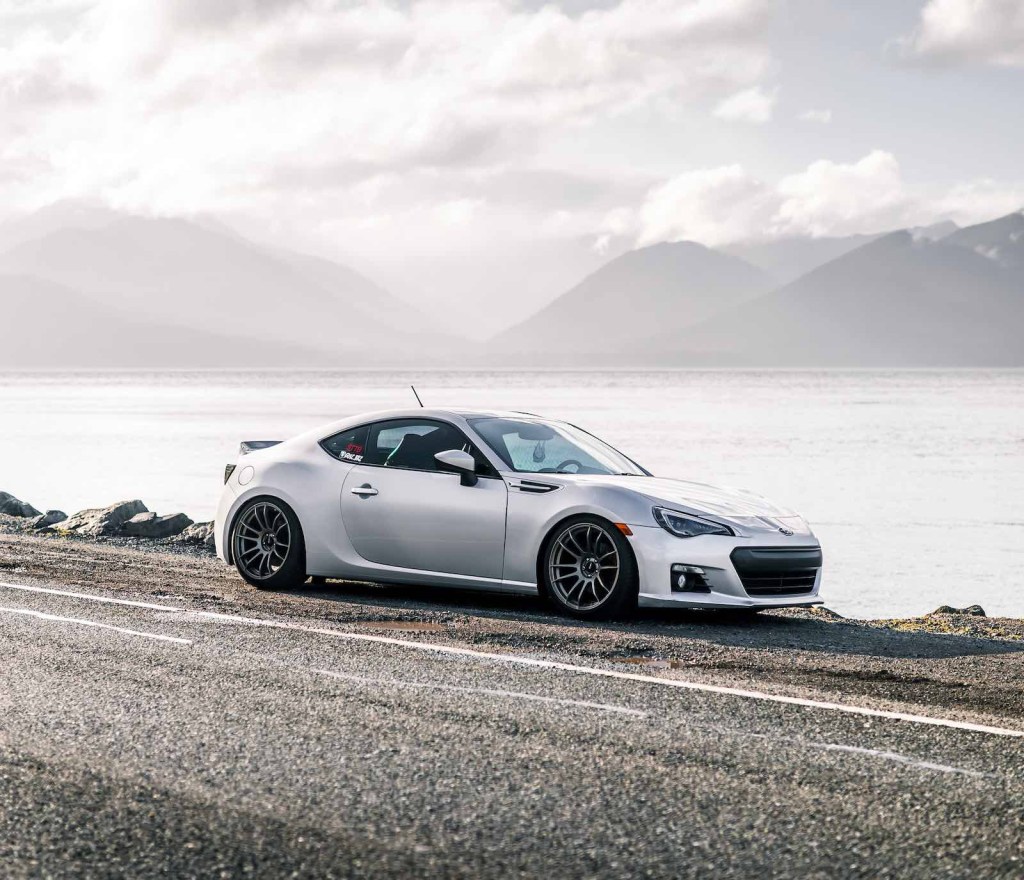 Silver Subaru BRZ parked by a river