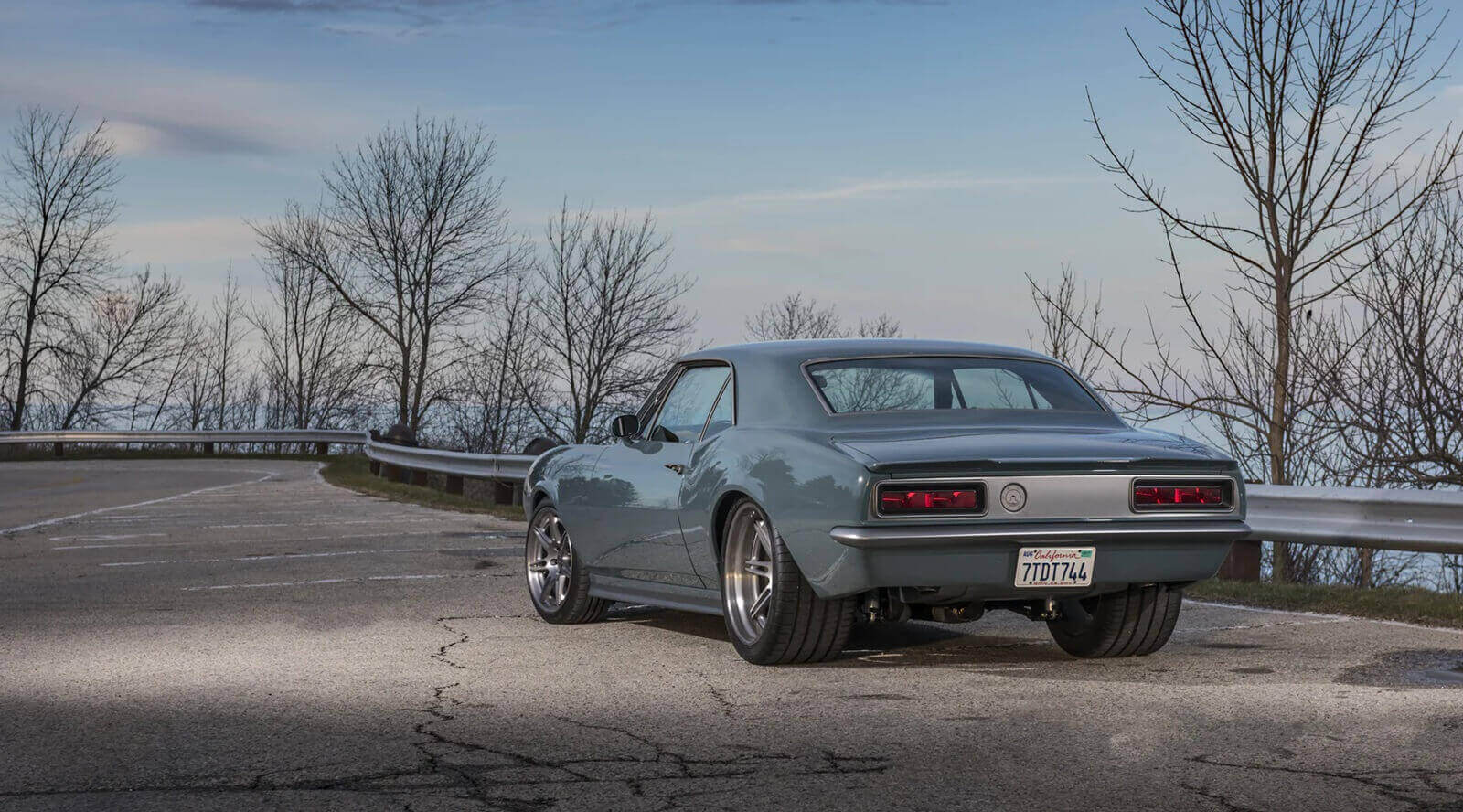 A SpeedKore 1967 Chevrolet Camaro custom build parks on the road. 