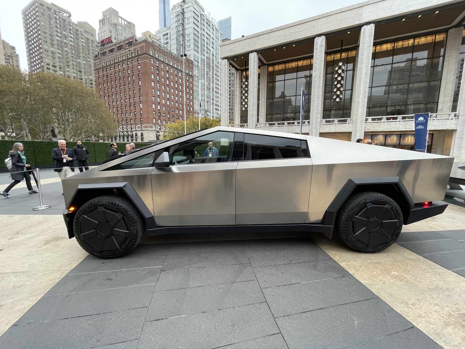 Tesla Cybertruck electric vehicle parked in a city plaza.