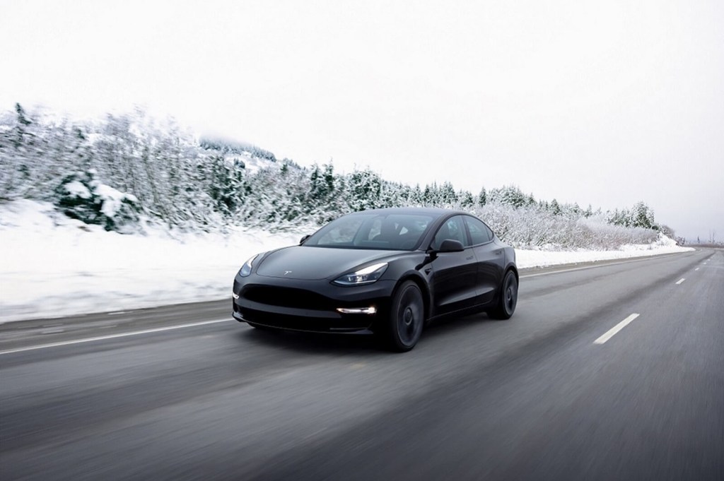 A Tesla Model 3 EV in the snow.