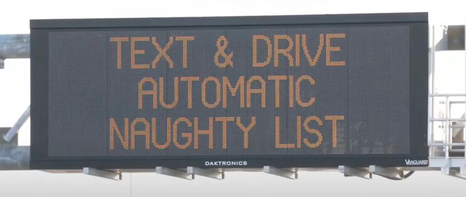 Sign above New Jersey highway reads Text & Drive: Automatic Naughty List