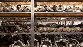 Row of scrap engines and transmissions from Ford F-150 Triton truck.