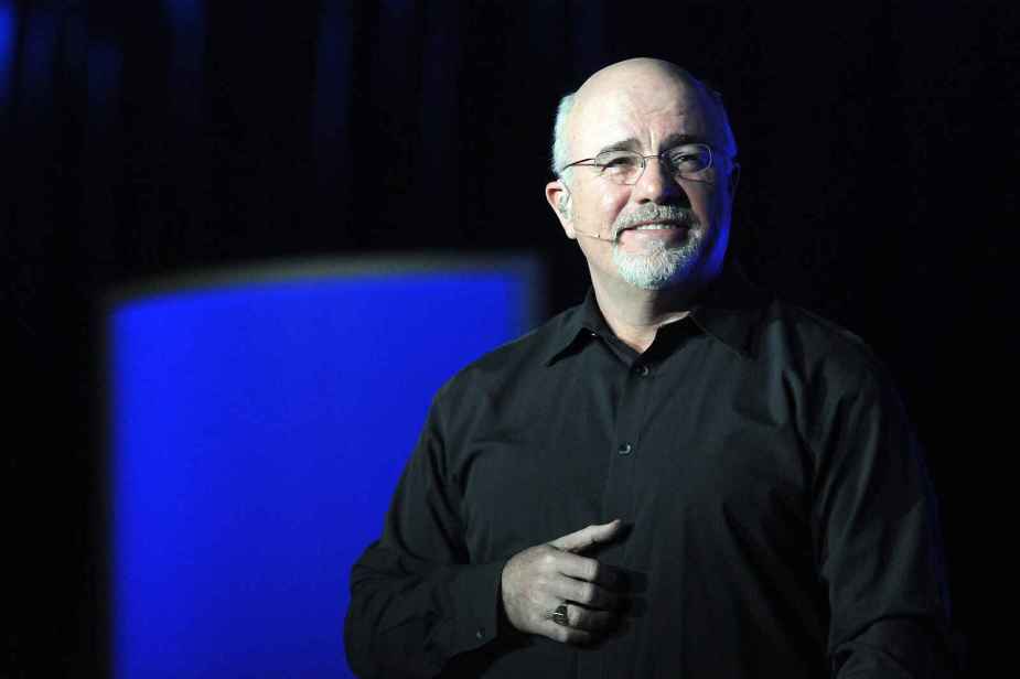 Dave Ramsey speaking at an event in 2011 giving money advice including best way to buy a car wearing a black shirt and blue and black background