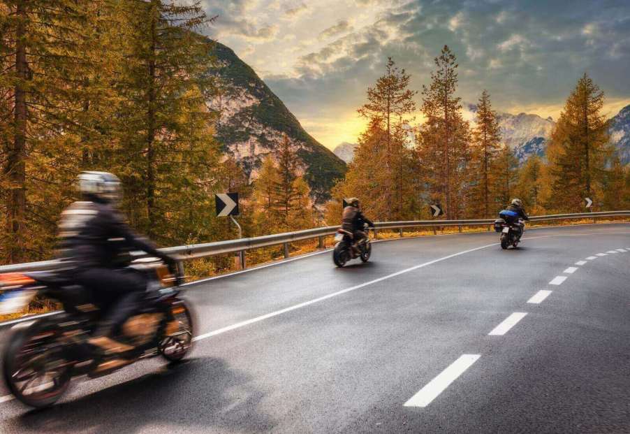 A set of motorcycle riders head into the mountains.