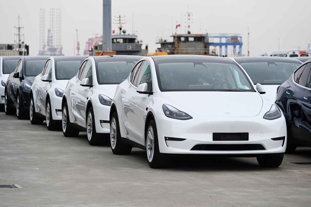 A group of Tesla Model Y and Model 3 EVs are shown parked outside waiting to be exported out of Shanghai