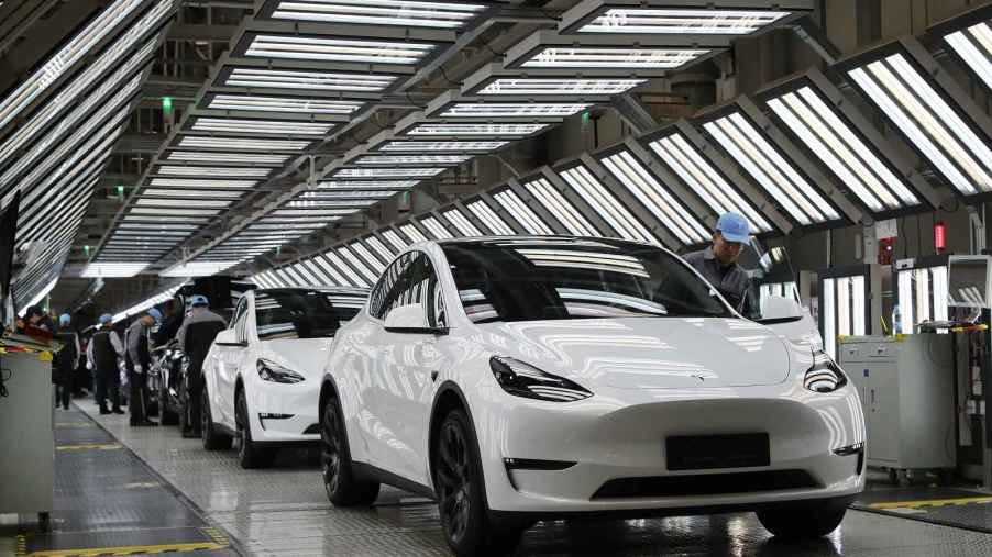 A row of white Tesla cars are shown on the factory floor in Shanghai