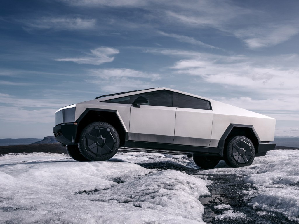 The Tesla Cybertruck parked on rocky terrain