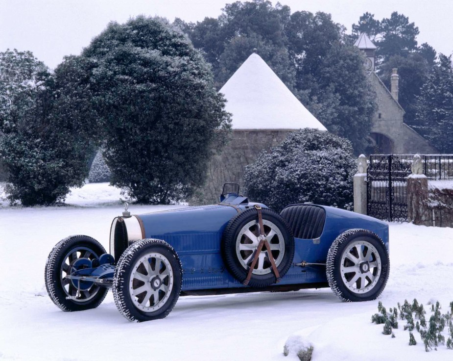 Blue Bugatti grand prix Roadster parked on snow.