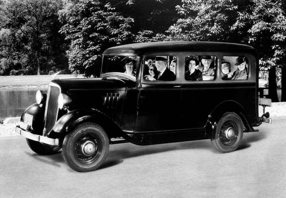 A 1935 Chevrolet Suburban Carryall is pitchered in black and white with eight passengers including 3 children the first American production SUV